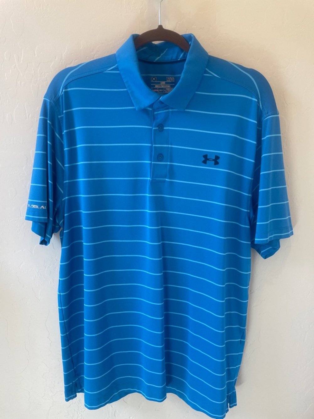 Size L Under Armour loose fit golf polo.
Mid blue with aqua stripes, navy logos.